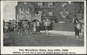London Olympics - 'The Marathon, Dorando Passing through Harrow' (1908) - Used Postcard London Olympics - 'The Marathon, Dorando Passing through Harrow' (1908) - Used Postcard